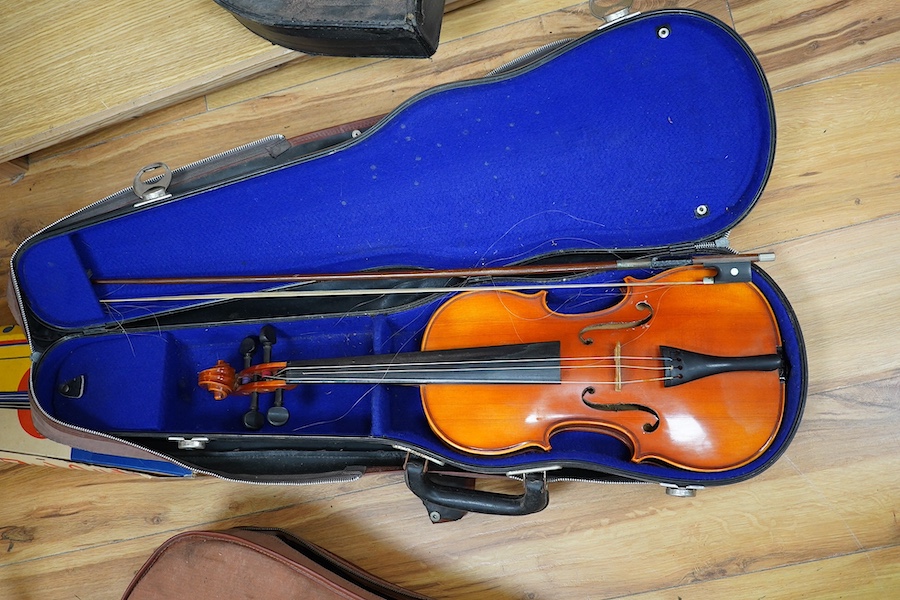 A quantity of violin parts and violins, a ukelele, a double bass scroll, a pinfold metronome, a violin case by Hill, a viola etc. Condition - for restoration